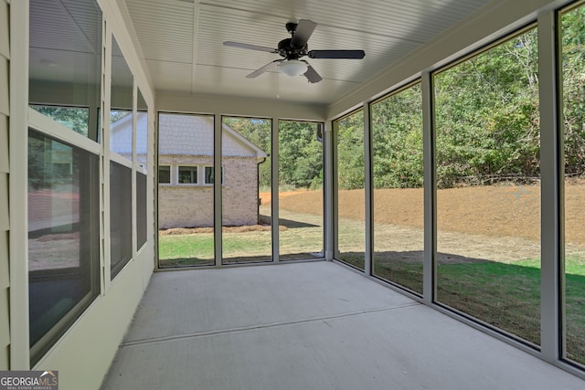 unfurnished sunroom with ceiling fan