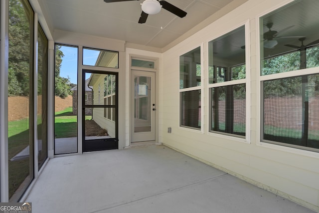 unfurnished sunroom with ceiling fan