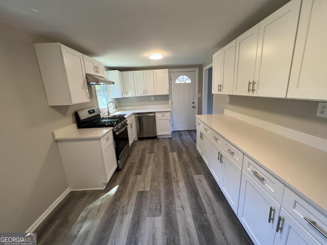 kitchen featuring stainless steel appliances, white cabinetry, dark hardwood / wood-style floors, and sink