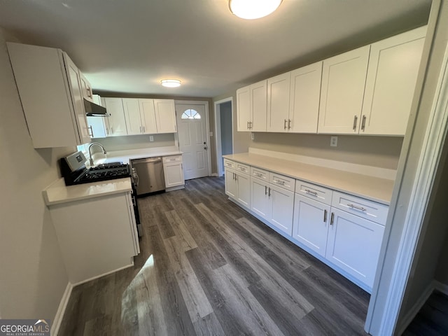 kitchen with ventilation hood, dark hardwood / wood-style floors, white cabinetry, and stainless steel dishwasher