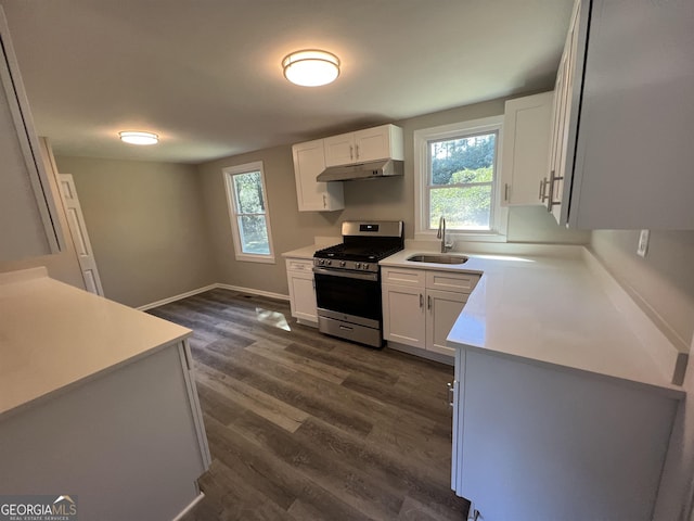 kitchen with dark hardwood / wood-style flooring, sink, white cabinetry, and stainless steel range with gas stovetop