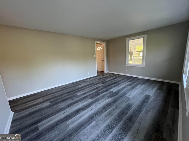 unfurnished room featuring dark hardwood / wood-style floors