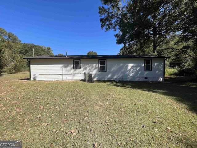 rear view of property with a lawn