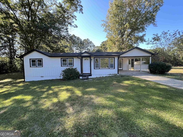 ranch-style home featuring a front yard and a carport