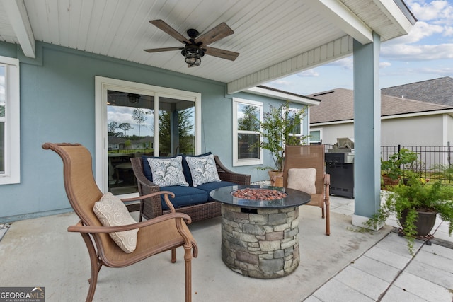 view of patio / terrace with an outdoor kitchen, ceiling fan, and an outdoor fire pit