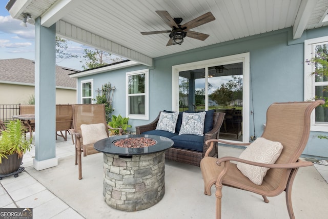 view of patio / terrace with ceiling fan and a fire pit