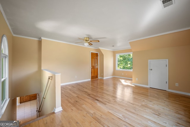 unfurnished living room featuring ceiling fan, light hardwood / wood-style floors, and ornamental molding