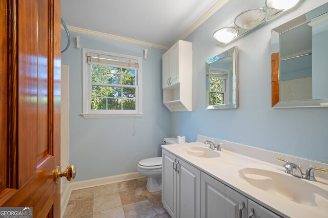 bathroom featuring tile patterned flooring, crown molding, toilet, and vanity