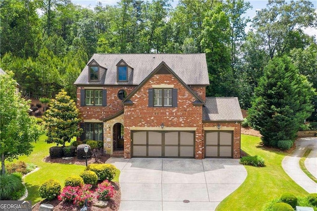 view of front of house featuring a garage and a front lawn