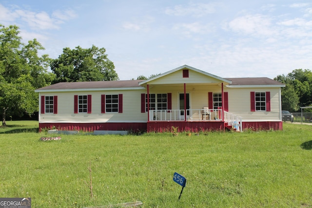 view of front facade with covered porch and a front yard