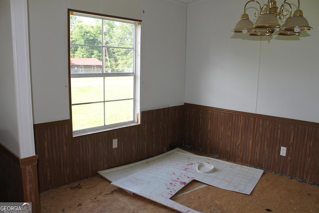 spare room with a notable chandelier