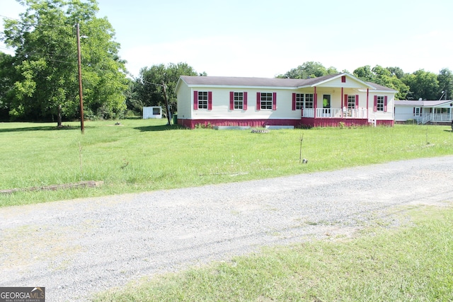 view of front of house featuring covered porch and a front yard