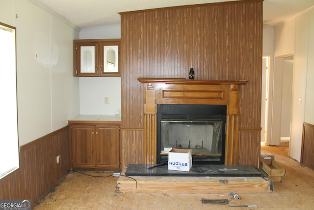 interior details with a textured ceiling and wooden walls