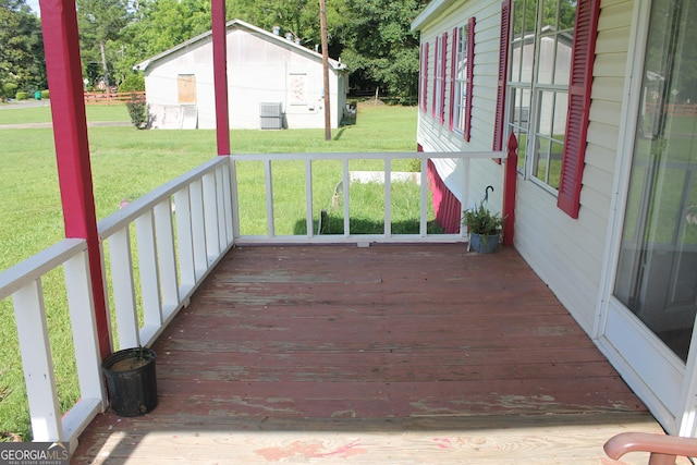 wooden terrace featuring a yard