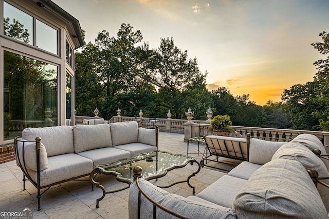 patio terrace at dusk featuring an outdoor hangout area