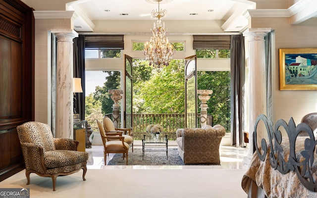 interior space with a notable chandelier, ornamental molding, and decorative columns