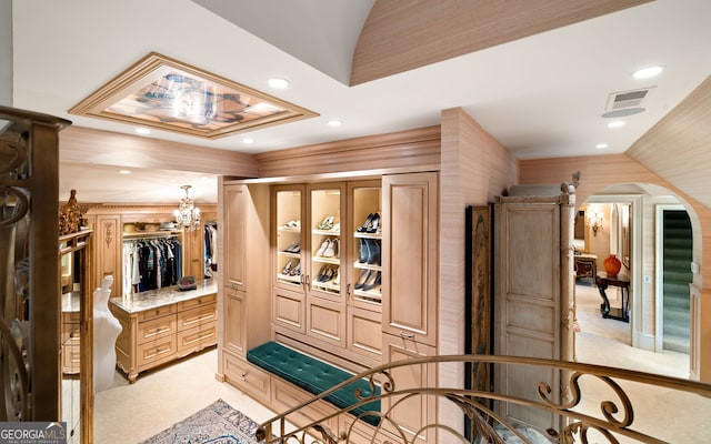 interior space with a notable chandelier, lofted ceiling, and light colored carpet