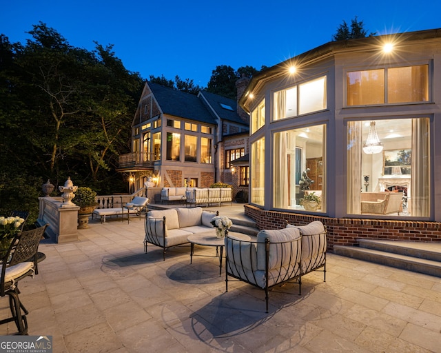 patio terrace at twilight featuring outdoor lounge area