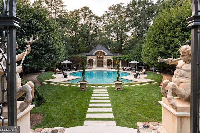 view of pool featuring a patio area and a lawn