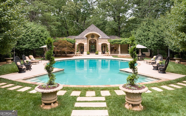 view of pool with a yard and a patio area