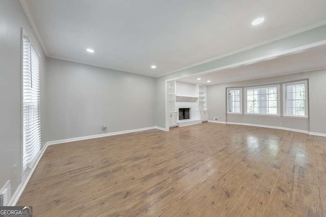 unfurnished living room featuring crown molding and light hardwood / wood-style floors