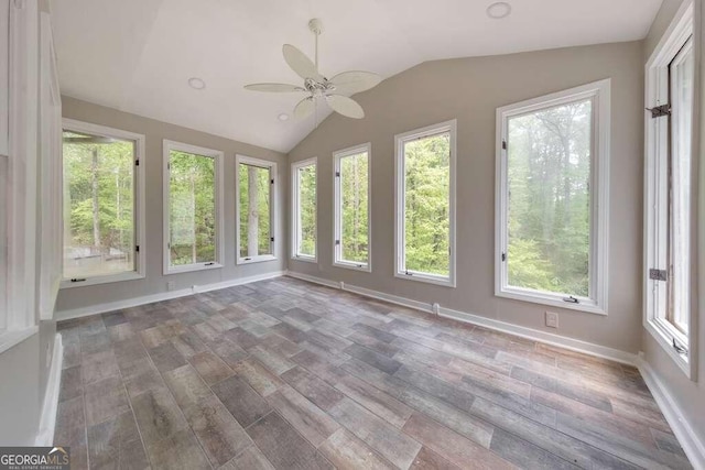 unfurnished sunroom featuring ceiling fan, plenty of natural light, and lofted ceiling