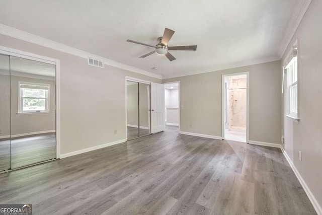 spare room with ceiling fan, ornamental molding, and wood-type flooring