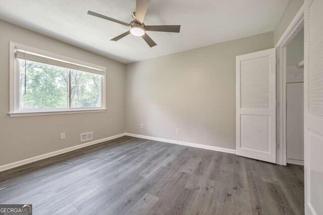 unfurnished bedroom with ceiling fan and hardwood / wood-style floors