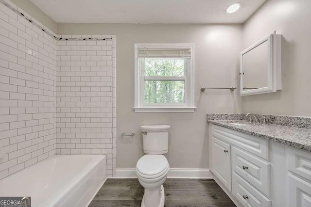 full bathroom featuring wood-type flooring, toilet, shower / tub combination, and vanity