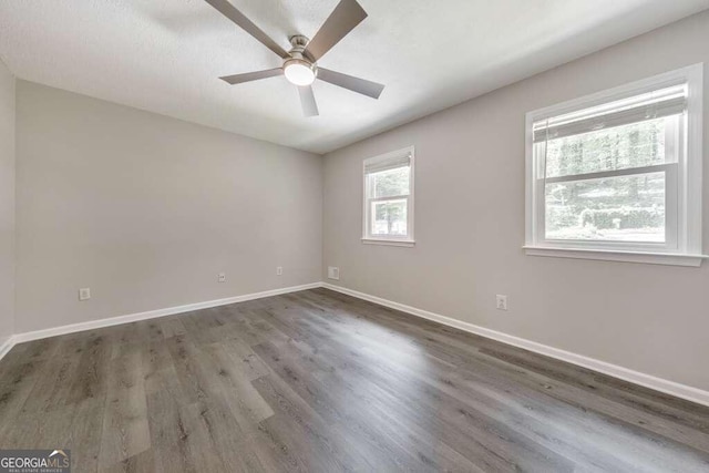 spare room with ceiling fan and wood-type flooring