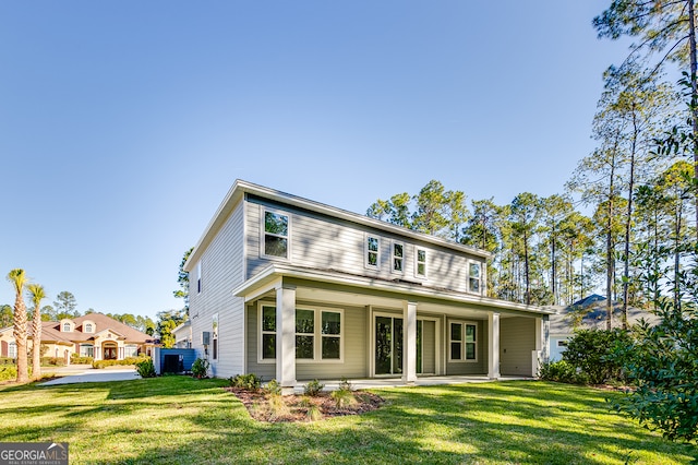 rear view of property featuring a lawn