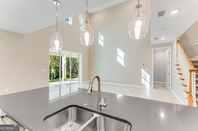 kitchen with sink, light tile patterned floors, and decorative light fixtures