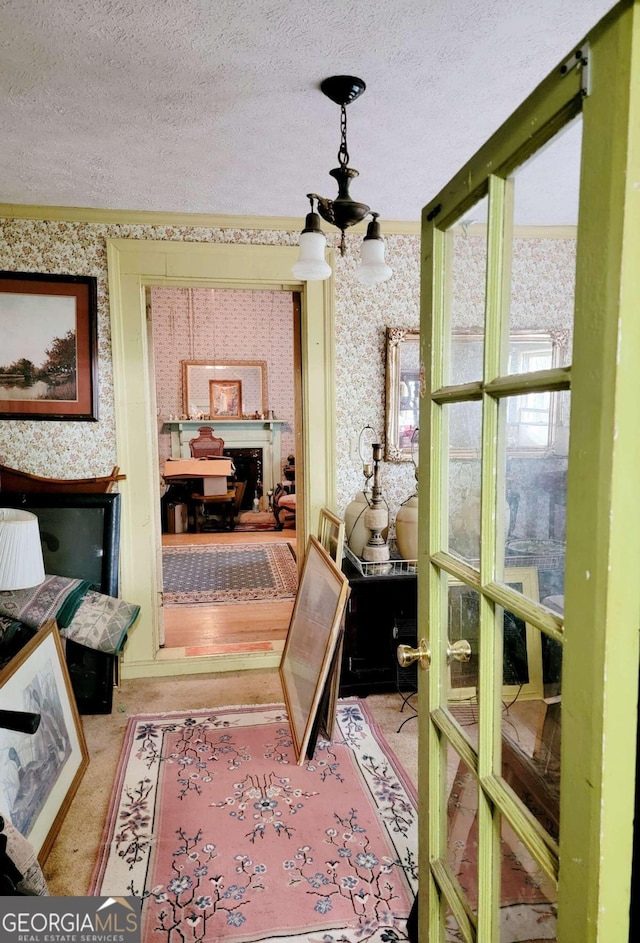 hall with crown molding and a textured ceiling