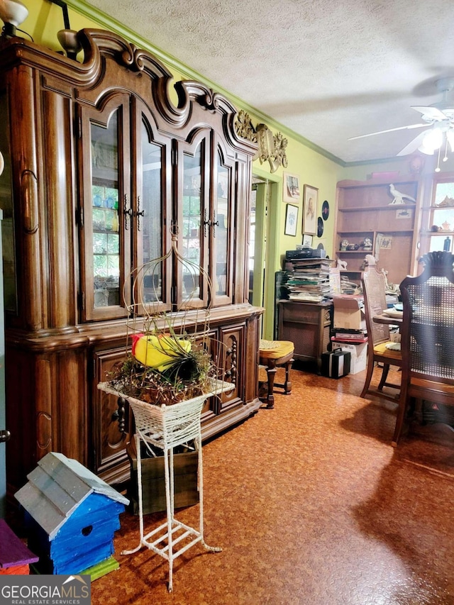 interior space with ceiling fan, a healthy amount of sunlight, crown molding, and a textured ceiling