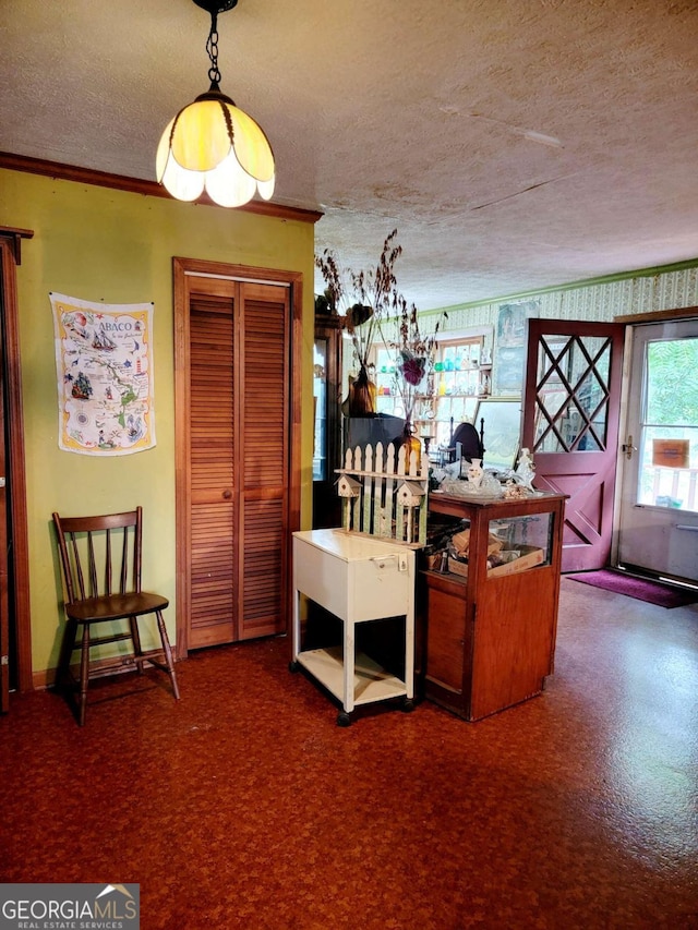 dining room featuring a textured ceiling and ornamental molding