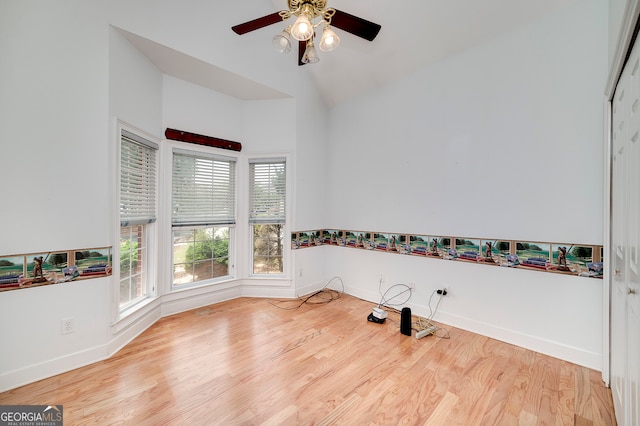 interior space featuring ceiling fan, light wood-type flooring, and vaulted ceiling