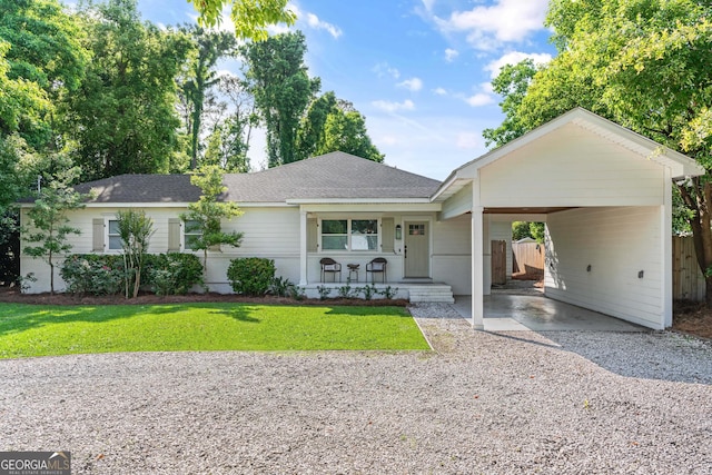 ranch-style house with a front lawn, a porch, and a carport