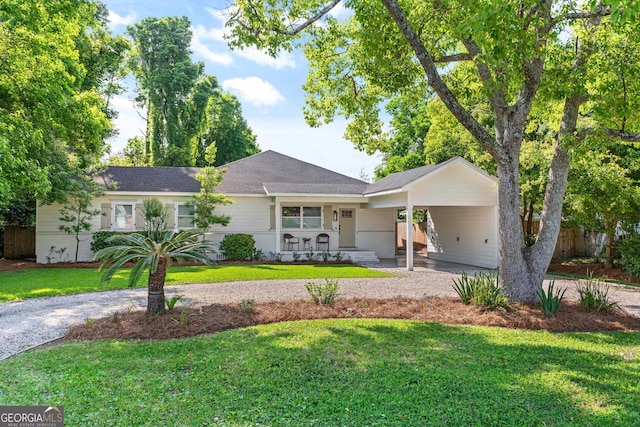 ranch-style house featuring a porch, a carport, and a front lawn