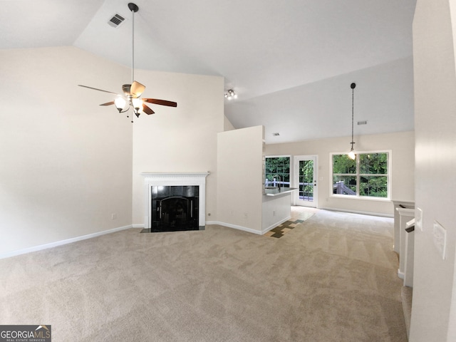 unfurnished living room with light carpet, high vaulted ceiling, ceiling fan, and a fireplace