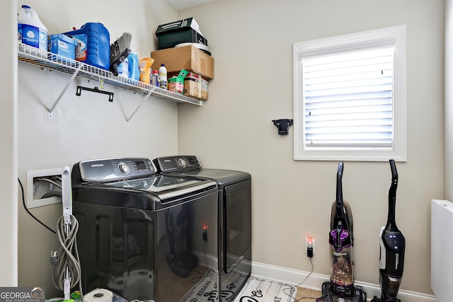 washroom featuring a healthy amount of sunlight and washing machine and clothes dryer