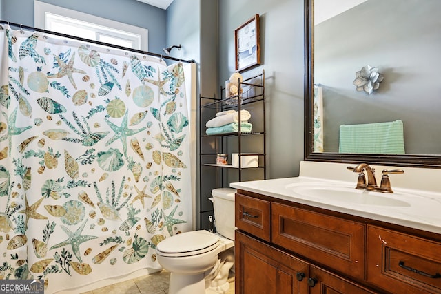 bathroom with tile patterned flooring, vanity, and toilet