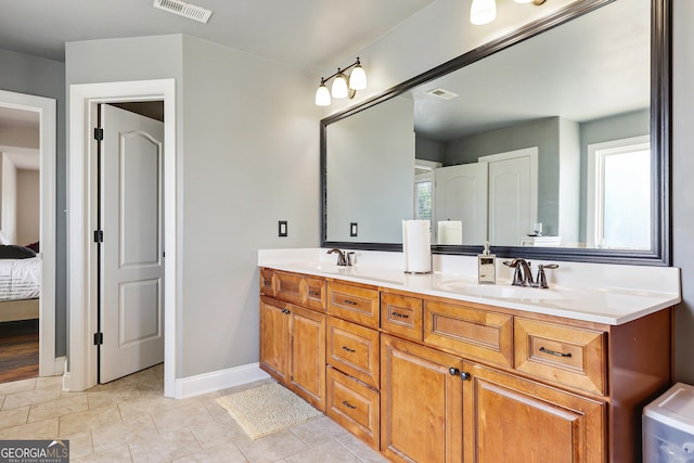 bathroom with tile patterned floors and vanity