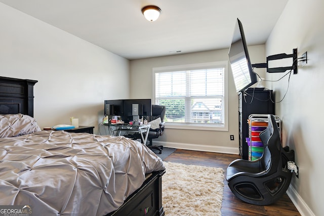 bedroom with dark wood-type flooring