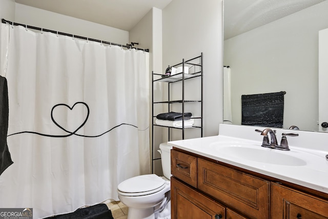 bathroom with tile patterned flooring, vanity, and toilet