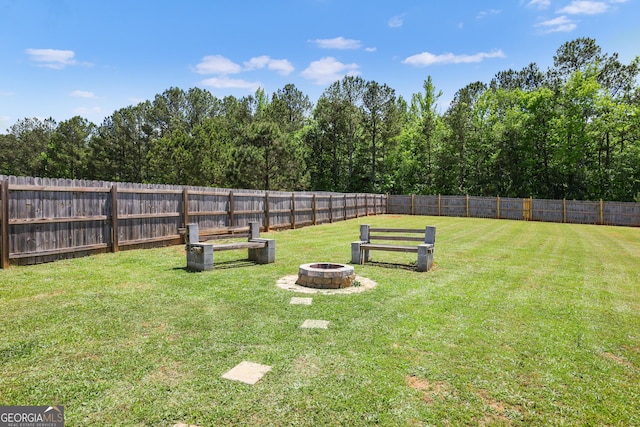 view of yard with an outdoor fire pit