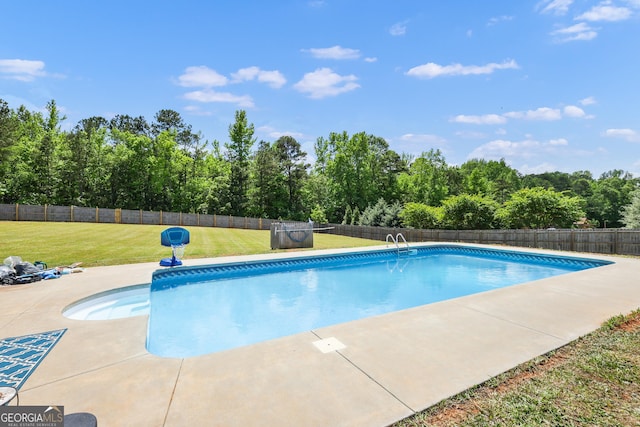 view of pool with a yard