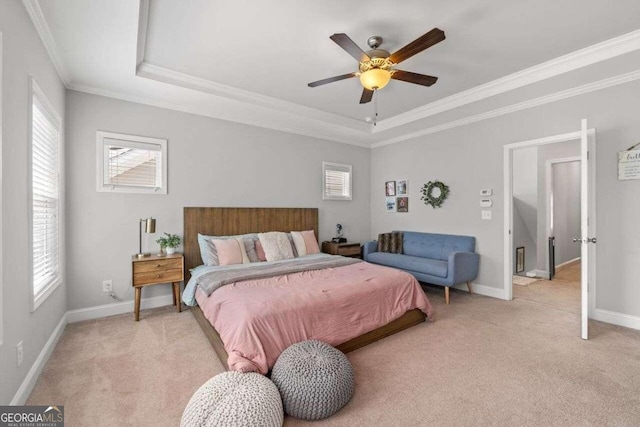 bedroom featuring light carpet, crown molding, a raised ceiling, and ceiling fan