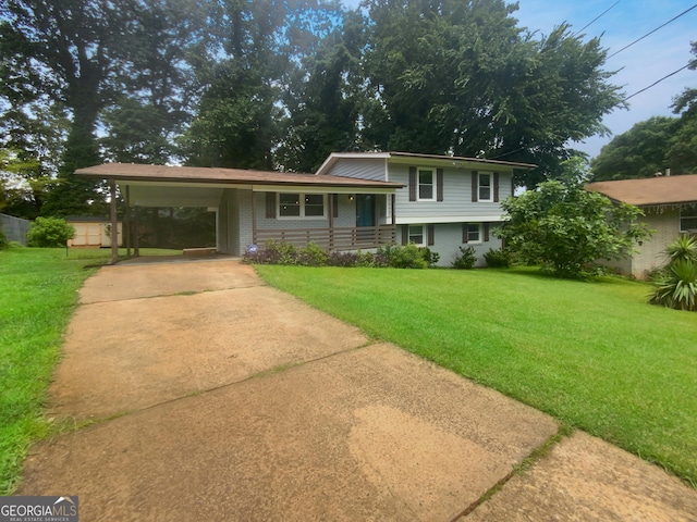 tri-level home featuring a front lawn and a carport