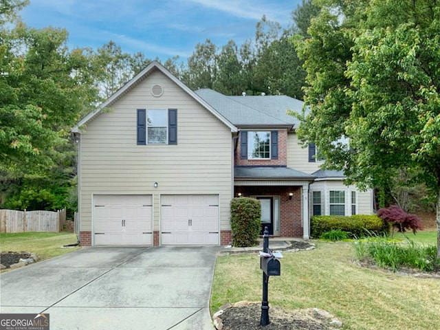 view of property featuring a garage and a front lawn