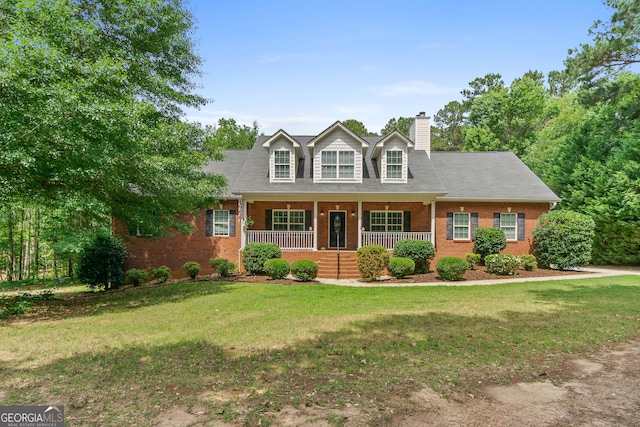 cape cod home featuring a porch and a front lawn